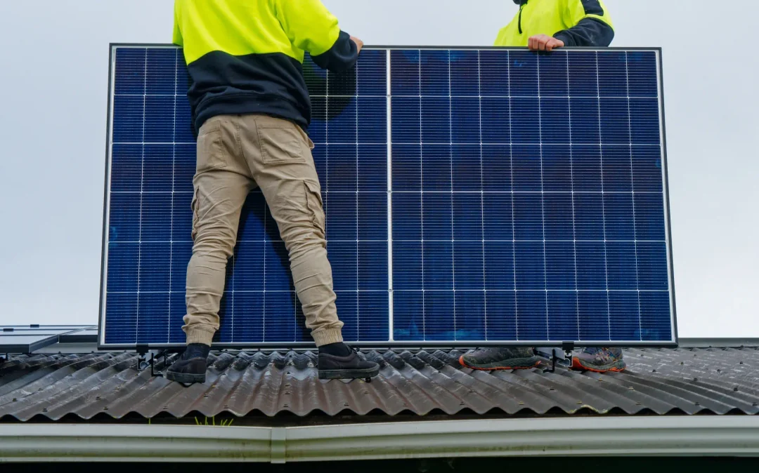 Two men with a solar panel